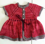 handknit raglan baby dress; Malabrigo Silky Merino Yarn, color 401 raspberry