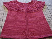 handknit child's sweater dress;