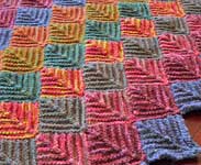 handknit multi-colored blanket; Malabrigo Worsted Merino Yarn color VAA, paris night, velvet grapes, stone chat & roanoke