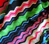 handknitted multi-color blanket; Malabrigo Merino Worsted Yarn color bobby blue, black & paris night