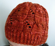 Hermione's Cable & Eyelet Hat free knitting pattern; Malbrigo Worsted Merino, color 194 cinnabar