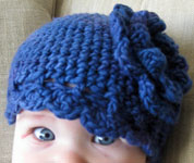handknit flowered baby cap, hat; Malabrigo Worsted Merino Yarn color indigo 88
