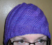 Swirl Hat, cap free knitting pattern; Malabrigo Worsted Yarn, color purple magic #609