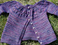 Hand knit child's cardigan knit with Malabrigo Sock Yarn color abril