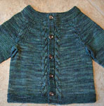 Hank knit child's cabled cardigan sweater with Malabrigo Merino Sock Yarn color aguas