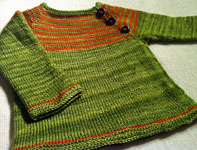 Hand-knit tow-toned child's dress with Malabrigo Merino Sock Yarn color lettuce and terracotta