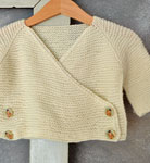Hand-knit baby garter stitch cardigan sweater with Malabrigo Merino Sock Yarn color natural