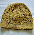 Hand-knit cabled hat/tam made with Malabrigo Merino Sock Yarn color ochre