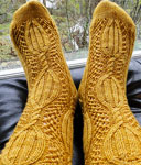 Hand-knit cabled socks made with Malabrigo Merino Sock Yarn color ochre