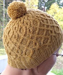 Hand-knit cabled hat/tam made with Malabrigo Merino Sock Yarn color ochre