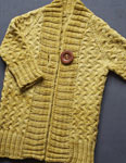 Hand-knit cardigan sweater made with Malabrigo Merino Sock Yarn color ochre