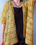 Hand-knit lacey cardigan sweater made with Malabrigo Merino Sock Yarn color ochre