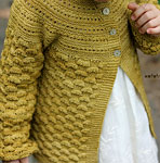 Hand-knit child's cardigan sweater made with Malabrigo Merino Sock Yarn color ochre