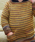 Hand-knit long sleeved child's pullover sweater made with Malabrigo Merino Sock Yarn color ochre and primavera