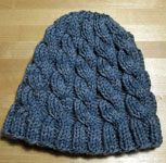 Hand-knit cabled hat using Malabrigo Merino Sock Yarn color persia