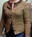 Hand-knit cabled cardigan sweater using Malabrigo Merino Sock Yarn color primavera