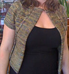 Hand-knit open front short-sleeved cardigan sweater using Malabrigo Merino Sock Yarn color primavera