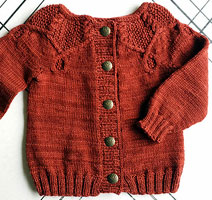 Pomander child's cabled cardigan sweater knit with Malabrigo Merino Sock Yarn color botticelli red