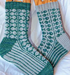 Hand-knit fair isle socks knit with Malabrigo Merino Sock Yarn colors solis and gray