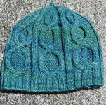 Hand-knit cabled hat/cap knit with Malabrigo Merino Sock Yarn color solis