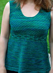 Hand-knit cabled sweater vest knit with Malabrigo Merino Sock Yarn color solis
