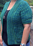 Hand-knit short-sleeved open front Cardigan knit with Malabrigo Merino Sock Yarn color solis